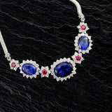 Custom platinum necklace with tanzanite, diamonds and red rubies