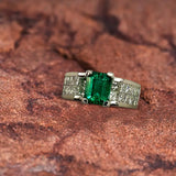 Platinum Ring With an Emerald Cut Emerald and Princess Cut Diamonds