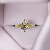 Platinum and 18K Gold Ring With a Natural Marquise Diamond and Yellow Triangle Cut Diamonds