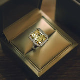 18K Gold Ring With a Radiant Cut Diamond and Natural Round White Diamonds