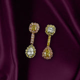 Diamond earrings featuring white, pink and vivid yellow diamonds