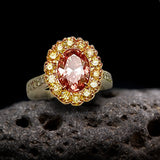 1.73 Ct. Oval Natural Deep Orangy-Pink VS2 with natural, yellow and white diamonds.